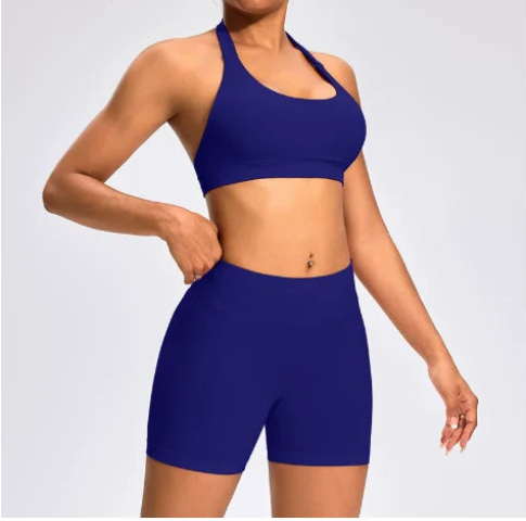 Front view of the Aura Halter Shorts Set in deep indigo, featuring a backless halter sports bra and high-waisted seamless activewear shorts.