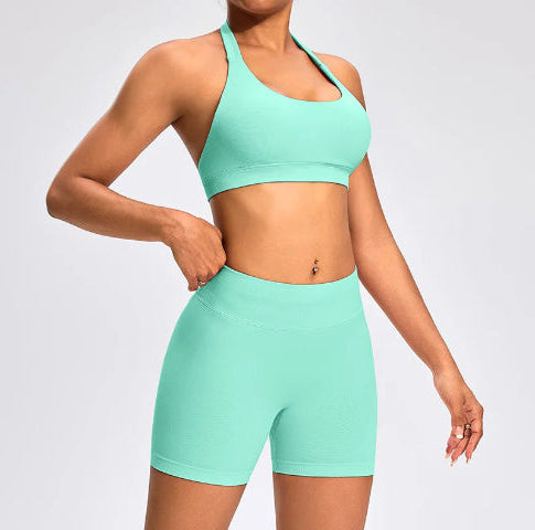 Front view of the Aura Halter Shorts Set in mint green, featuring a backless halter sports bra and high-waisted seamless activewear shorts.