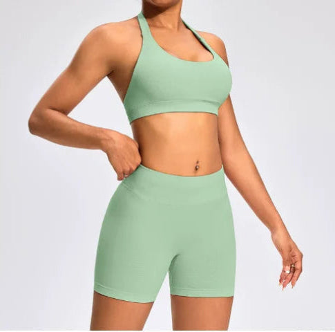 Front view of the Aura Halter Shorts Set in mint green, featuring a backless halter sports bra and high-waisted seamless training shorts.
