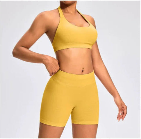 Front view of the Aura Halter Shorts Set in Mustard Yellow, featuring a backless halter sports bra and high-waisted seamless activewear shorts.