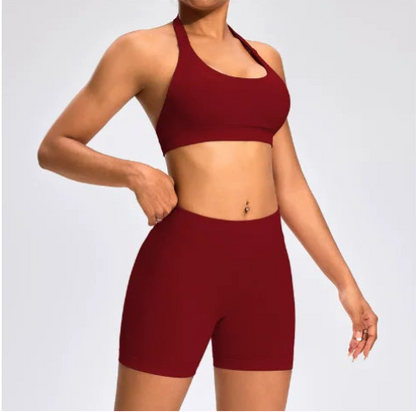 Front view of the Aura Halter Shorts Set in burgundy, featuring a backless halter sports bra and high-waisted seamless activewear shorts.