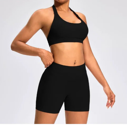Front view of the Aura Halter Shorts Set in black, featuring a backless halter sports bra and high-waisted seamless activewear shorts.